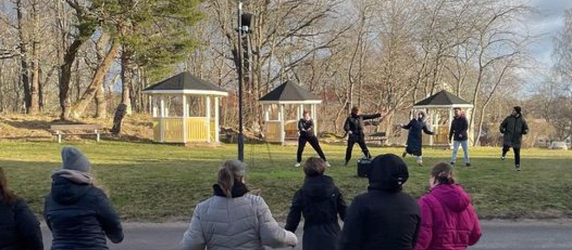 Personer utomhus som tränar tillsammans.
